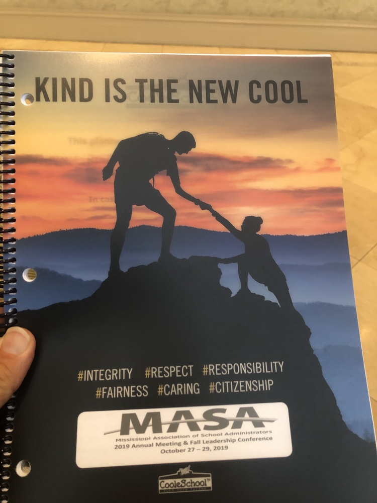 Photo of book that says "kind is the new cool"