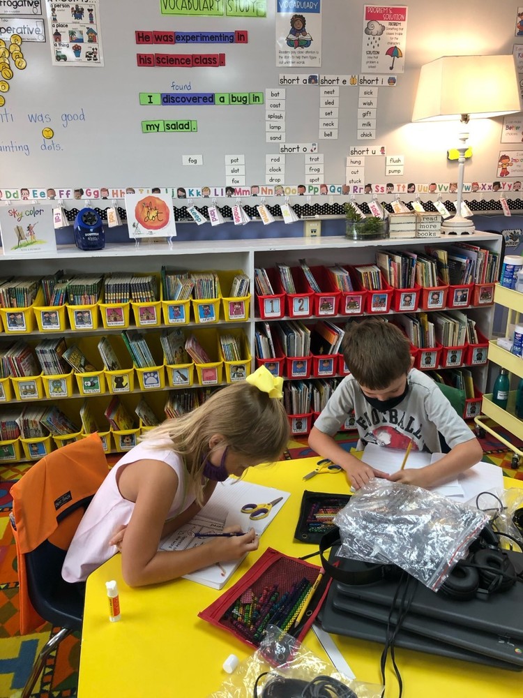 1st graders work in their vocabulary journals.